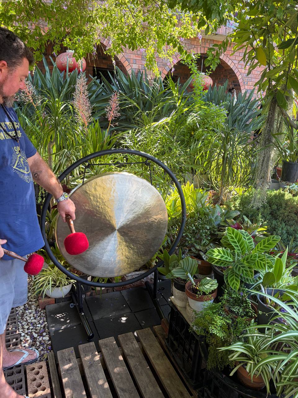 Luke with gongs in garden